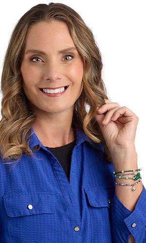 A smiling woman in blue wearing Design Idea R E 2 W