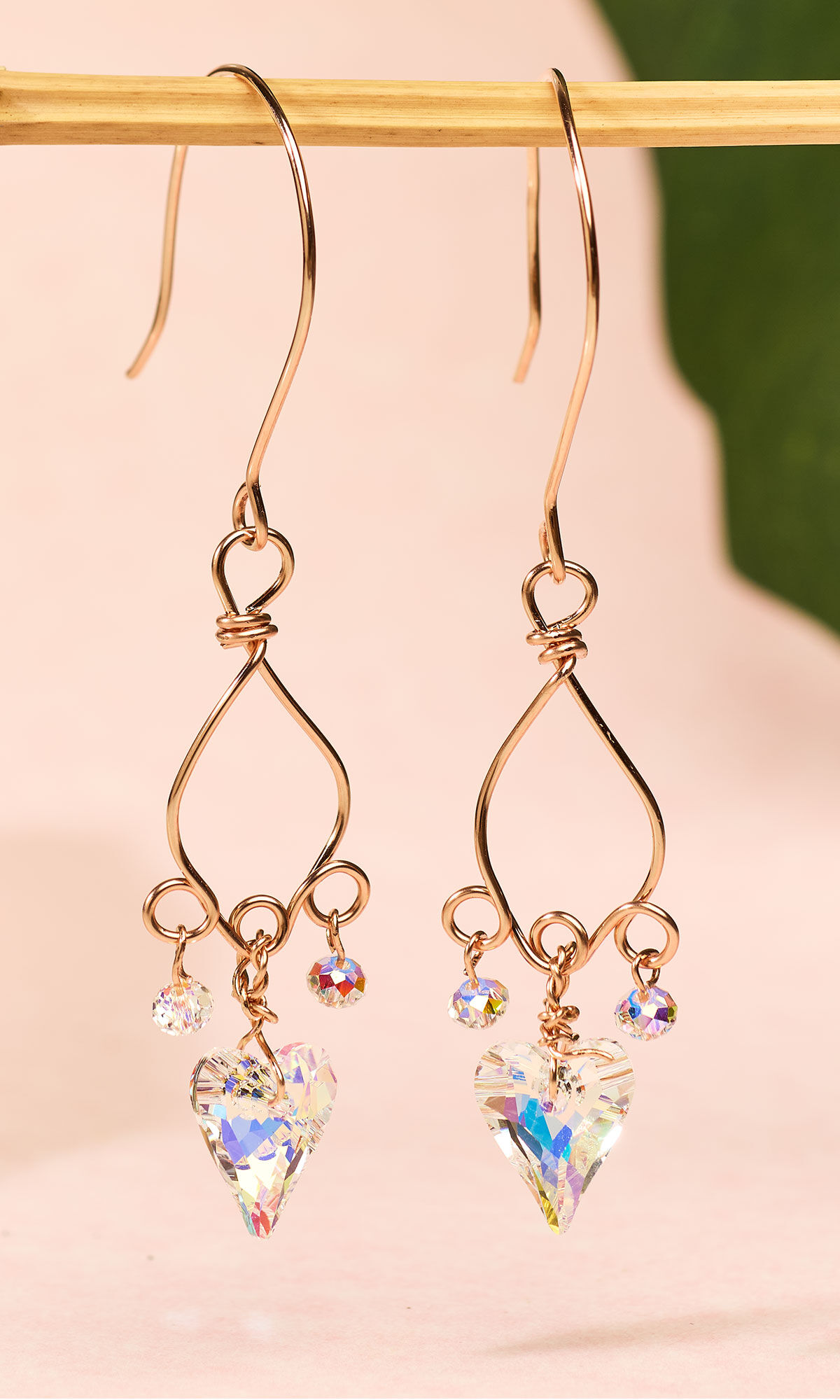 Design Idea QM37 hanging on a small gold bar over a pink cloth