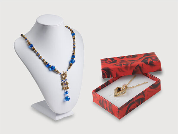 Jewelry displayed on a bust and a gift box