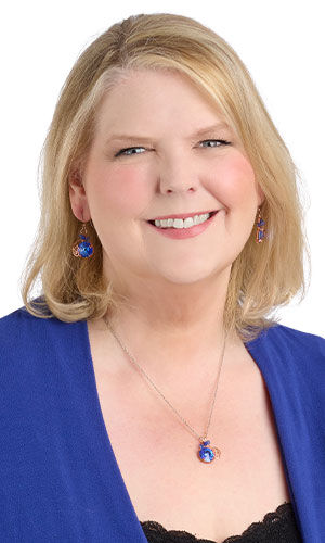 Smiling woman in blue wearing design Idea P M 3 F
