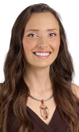 Smiling woman in brown wearing Design Idea R D 2 7