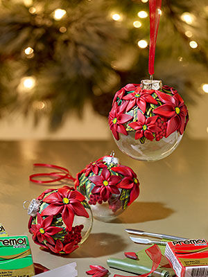 Ornaments displayed with a Christmas tree in the background