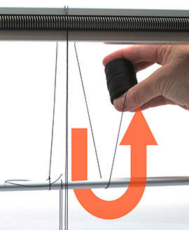 Step 13 - The thread goes back under the warping bar and back up