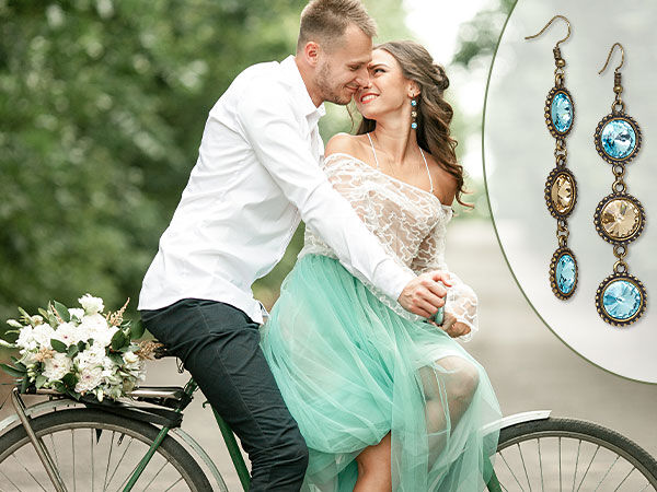 A couple on a bike and a Pair of blue and gold earrings