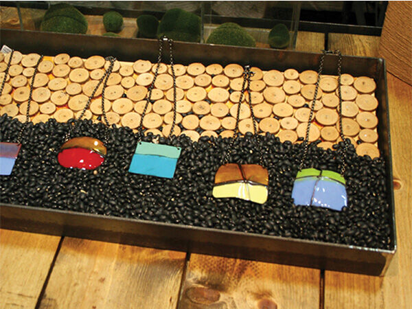 Enameled jewelry in a display tray