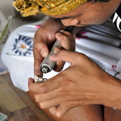 Person carving bone using a rotary tool