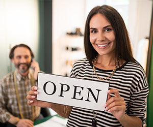 Woman holding an Open sign