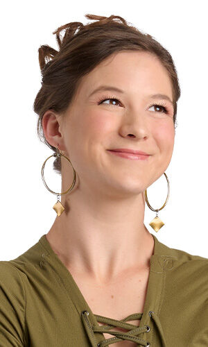 A smiling woman in green wearing Design Idea R D 2 D
