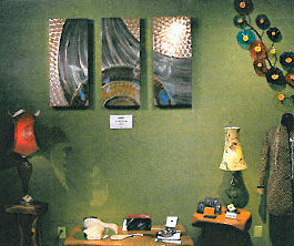 Art displayed with a green wall background