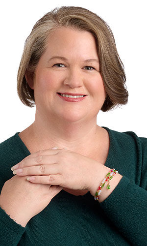 A woman in green wearing Design Idea R E 2 D