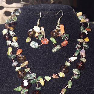 Necklace and earrings on a black display