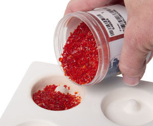 red frit being poured into the mold