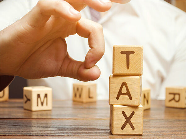 Letter blocks spelling the word "tax"