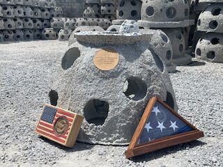 Frank's reef with a folded American flag leaning against it
