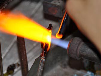 Heating shaped glass