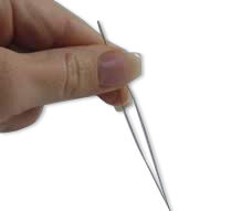 A hand holding a needle