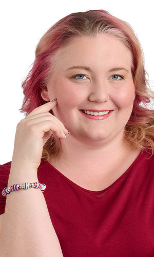 A smiling woman in red wearing Design Idea R F 2 2