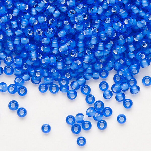 Seed bead, Preciosa Ornela, glass, transparent chalkwhite-lined sapphire, #8 rocaille. Sold per 50-gram pkg. image number 0