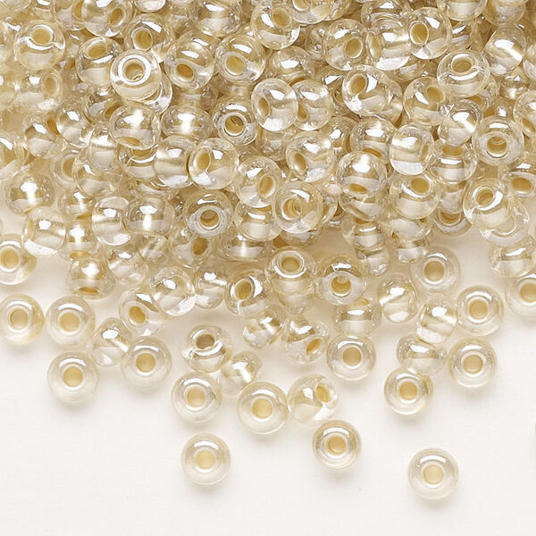 Seed bead, Preciosa Ornela, glass, translucent mocca pearl-lined crystal clear, #6 rocaille. Sold per 500-gram pkg. image number 0