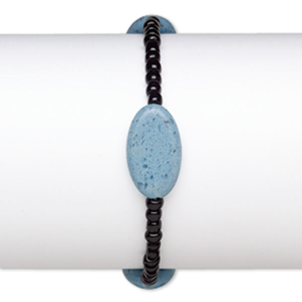 Bracelet, stretch, glass, opaque black and blue, 4x3mm-5x4mm rondelle and 23x13mm-23x14mm puffed oval, 7 inches. Sold individually. image number 0