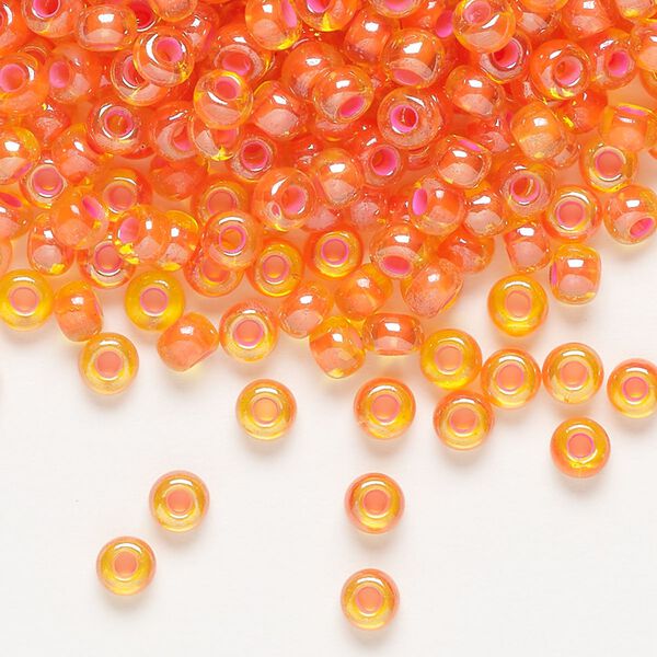 Seed bead, Preciosa Ornela, glass, translucent pink-lined luster yellow amber, #6 rocaille. Sold per 500-gram pkg. image number 0