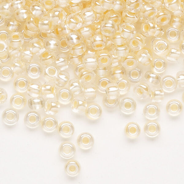 Seed bead, Preciosa Ornela Czech glass, pkg/500g, #6 rocaille, translucent color-lined luster pastel apricot, (382PA). image number 0