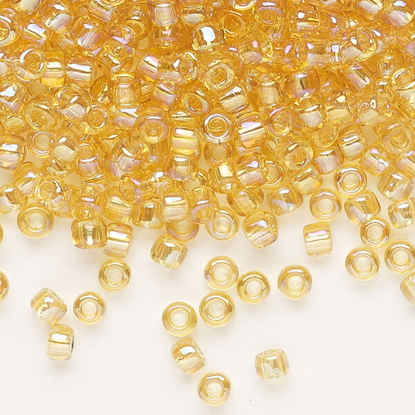 Seed bead, Dyna-Mites™, glass, transparent rainbow amber yellow, #6 round. Sold per 1/2 kilogram pkg. image number 0