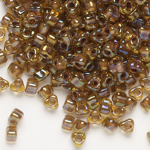 Seed bead, Miyuki, glass, transparent dark amber yellow color-lined purple, (TR1162), #5 triangle. Sold per 250-gram pkg. image number 0