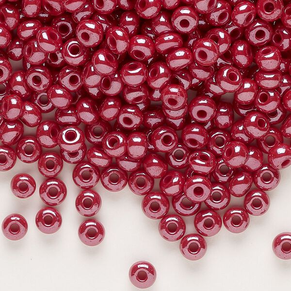 Seed bead, glass, pkg/50g, #6 rocaille, opaque luster dark red. image number 0