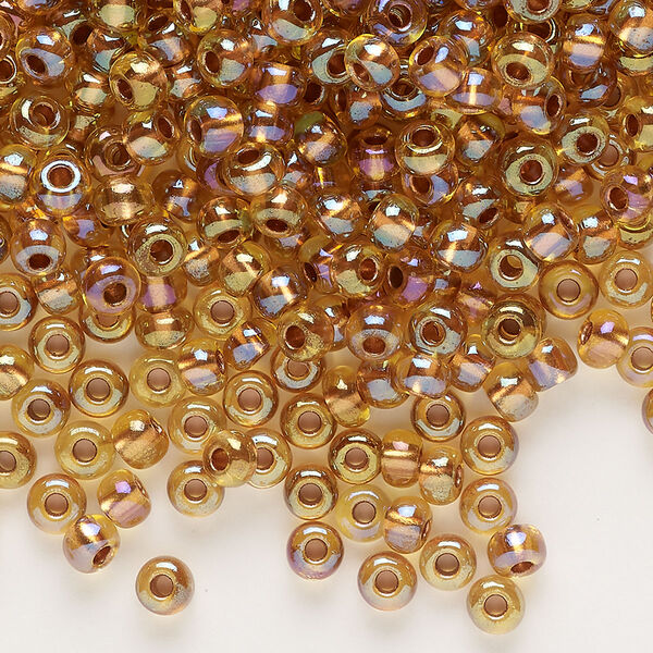 Seed bead, glass, pkg/50g, #6 rocaille, translucent color-lined copper iris beige. image number 0