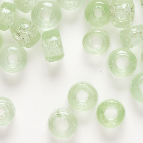 Bead, glass, transparent light green, 9x7mm crow. Sold per pkg of 100. image number 0