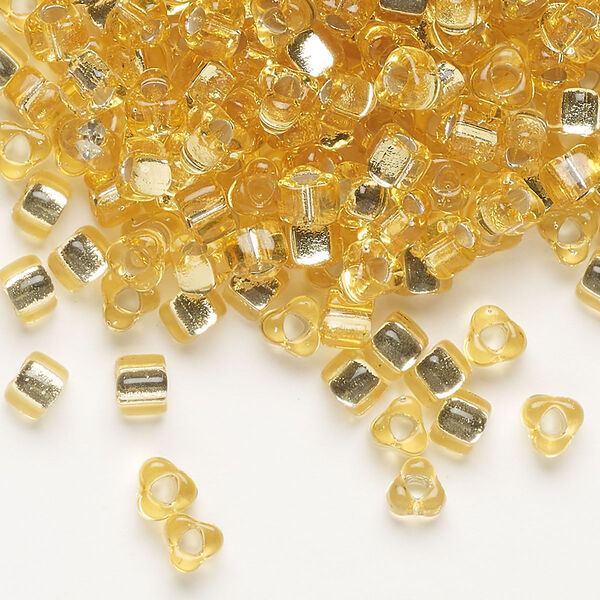 Seed bead, Miyuki, glass, silver-lined translucent amber yellow, (TR1102), #5 triangle. Sold per 25-gram pkg. image number 0