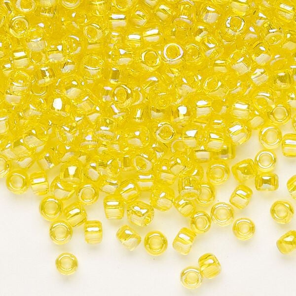 Seed bead, Dyna-Mites™, glass, transparent rainbow yellow, #6 round. Sold per 1/2 kilogram pkg. image number 0
