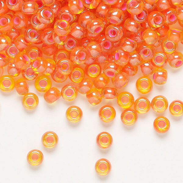 Seed bead, Preciosa Ornela, glass, translucent pink-lined luster yellow amber, #6 rocaille. Sold per 500-gram pkg. image number 0