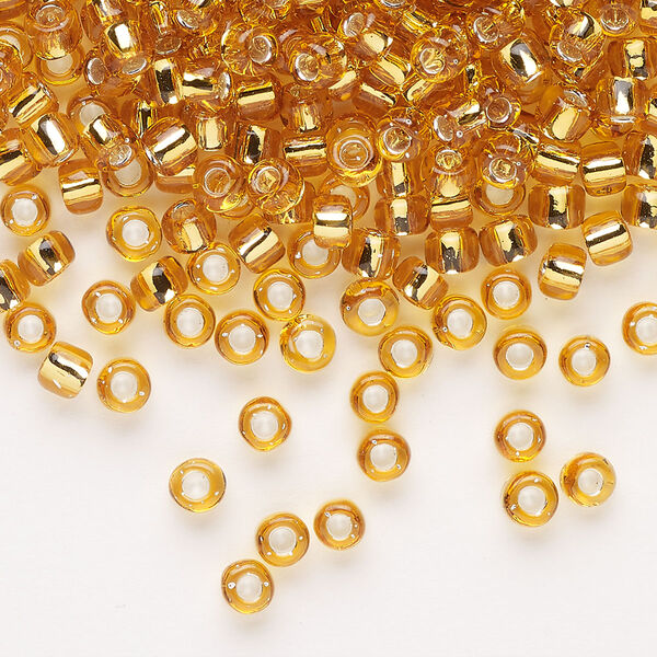 Seed bead, Dyna-Mites™, glass, transparent silver-lined gold, #6 round. Sold per 1/2 kilogram pkg. image number 0