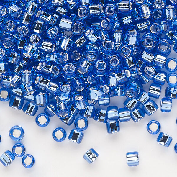 Seed bead, Dyna-Mites™, glass, silver-lined translucent blue, #6 round with square hole. Sold per 1/2 kilogram pkg. image number 0